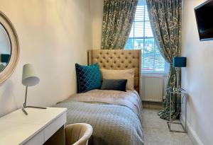 A bed or beds in a room at Old Daltongate House