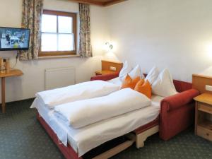 een hotelkamer met twee bedden en een televisie bij Apartment Gredler-1 by Interhome in Mayrhofen +24 foto's