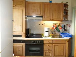 ゼーボーデンにあるHoliday Home Reier - BOD130 by Interhomeのキッチン(木製キャビネット、黒いコンロ付)
