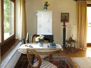 a living room with a table and a fireplace at Holiday Home Reier - BOD130 by Interhome in Seeboden