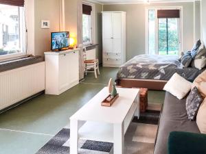 a living room with a bed and a couch at Holiday Home Heike by Interhome in Wandlitz