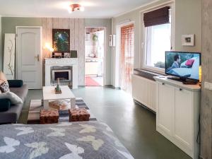 a living room with a bed and a television at Holiday Home Heike by Interhome in Wandlitz