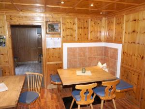 a dining room with a wooden table and chairs at Holiday Home Burgner by Interhome in Kappl