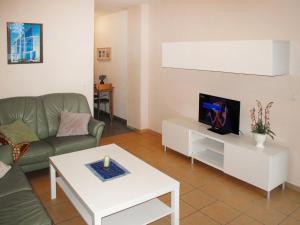 uma sala de estar com um sofá e uma mesa em Holiday Home Strandvilla - LUB117 by Interhome em Lubmin