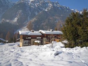 a house in the snow in front of a mountain at Holiday Home Les Pelarnys by Interhome in Chamonix