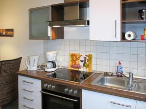 a kitchen with a sink and a counter top at Apartment Strandvilla - LUB110 by Interhome in Lubmin