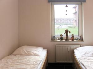 two twin beds in a room with a window at Apartment Lagunenstadt Ueckermünde-5 by Interhome in Ueckermünde