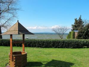 a gazebo with a roof in the grass at Holiday Home Am See II by Interhome in Verchen