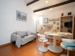 a living room with a couch and a table at Holiday Home Les Maisons de la Plage-4 by Interhome in Le Grau-du-Roi