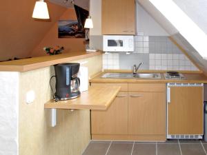 a small kitchen with a sink and a microwave at Apartment Seeblick by Interhome in Verchen