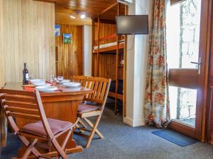 a dining room with a table and chairs and a bunk bed at Studio Le 2100 A et B - Lavachet-8 by Interhome in Tignes