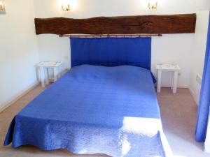 Saint-Georges-de-MonclardにあるApartment Astruga - GDM101 by Interhomeのベッドルーム1室(青いベッド1台、テーブル2台付)
