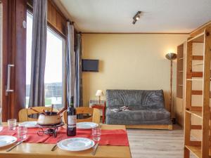 a living room with a table and a couch at Apartment Les Pistes-2 by Interhome in Tignes