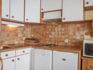 a kitchen with white cabinets and white appliances at Apartment Les Pistes - Lavachet-2 by Interhome in Tignes