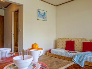 a living room with a table with dishes on it at Apartment Les Pistes-3 by Interhome in Tignes