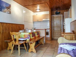 a small kitchen with a wooden table and chairs at Apartment Le 2100 A et B-7 by Interhome in Tignes