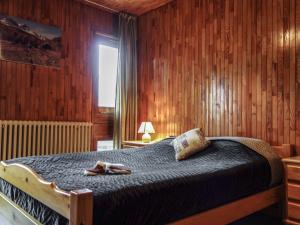 a bedroom with a bed with a pair of shoes on it at Apartment Le 2100 A et B-7 by Interhome in Tignes