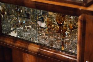 a bunch of glasses sitting on a glass table at Guesthouse Hoxha in Gjirokastër +35 photos