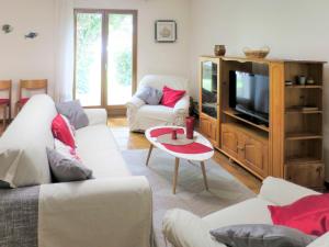 a living room with white couches and a tv at Holiday Home La Rose des Sables - RES120 by Interhome in Arès