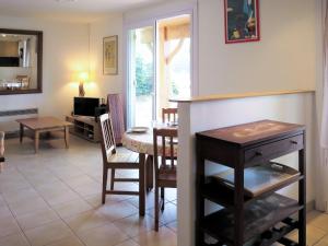 a living room with a table and a dining room at Holiday Home Anne Marie - LCA195 by Interhome in Lacanau-Océan