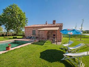 a house with a pool and two chairs and an umbrella at Holiday Home La Capannina by Interhome in La Croce