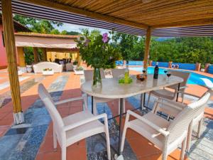 a patio with a table and chairs and a pool at Villa La Chiazza by Interhome in Corsanico-Bargecchia
