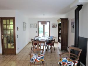 a dining room with a table and chairs and a fireplace at Holiday Home Caberal by Interhome in Soulac-sur-Mer