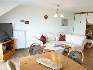 a living room with a couch and a table at Apartment Dehne-2 by Interhome in Norddeich