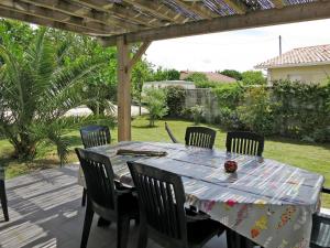 a table and chairs sitting on a patio at Holiday Home Dorgeles - SUL130 by Interhome in Soulac-sur-Mer