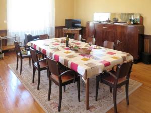 a dining room table with chairs and a table cloth at Holiday Home Lacapelle - LPR100 by Interhome in Lacapelle-Ségalar