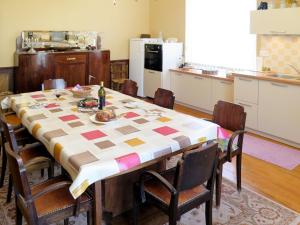 a kitchen with a table and chairs and a kitchen with a tableablish at Holiday Home Lacapelle - LPR100 by Interhome in Lacapelle-Ségalar