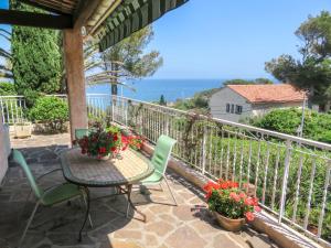 a patio with a table and chairs and the ocean at Holiday Home Carpe Diem by Interhome in Les Issambres