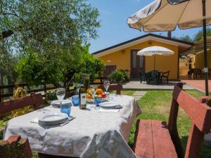 a table with plates of food on it in a yard at Holiday Home Le Bozzelle by Interhome in Corsanico-Bargecchia