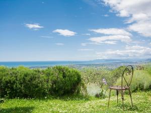 a chair sitting on top of a field of grass at Holiday Home Casaccia by Interhome in Mommio
