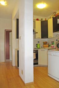 a kitchen with a white column in a room at Apartment Chantal-4 by Interhome in Rabac