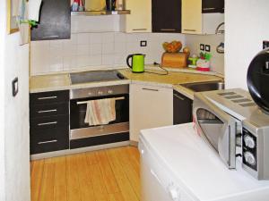 a small kitchen with a stove and a microwave at Apartment Chantal-4 by Interhome in Rabac +24 photos