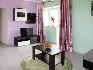 a living room with purple walls and a table with fruit on it at Holiday Home Mirela by Interhome in Martina