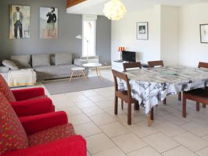 a living room with a table and a couch at Holiday Home La Chapelle - CON100 by Interhome in Contis-les-Bains