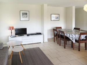 a living room with a table and a dining room at Holiday Home La Chapelle - CON100 by Interhome in Contis-les-Bains