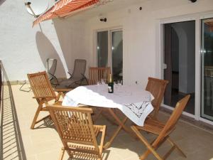 a table with a white table cloth on a patio at Apartment Luka - NOV103 by Interhome in Novi Vinodolski