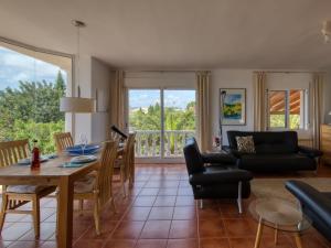 a living room with a table and a dining room at Holiday Home Osa Menor by Interhome in Montgo