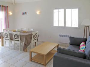 a living room with a table and a couch at Holiday Home Résidence Plage Océane - BPL340 by Interhome in Biscarrosse-Plage