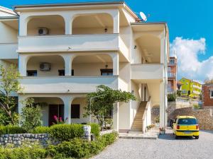 a yellow car parked in front of a building at Apartment Nikol - CKV123 by Interhome in Crikvenica