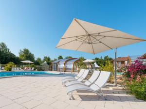 The swimming pool at or close to Holiday Home Les Cottages du Lac - PNS214 by Interhome