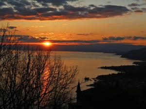 a sunset over a large body of water at Apartment View Riviera by Interhome in Glion