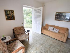 a living room with a couch and a chair at Apartment Villa Laura-4 by Interhome in Crone
