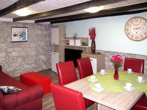 a dining room with a table and red chairs at Holiday Home Matea - MOD207 by Interhome in Martina