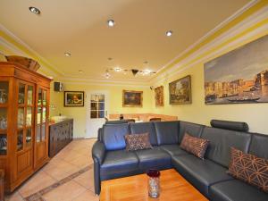 a living room with a couch and a table at Holiday Home Dünenrose by Interhome in Groß Zicker