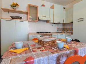 a kitchen with a table with a table cloth on it at Apartment Solmare-4 by Interhome in Rosapineta