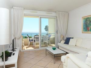 a white living room with a view of the ocean at Apartment Le Grand Large by Interhome in Juan-les-Pins